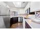 Kitchen features modern appliances, white cabinets, and sleek countertops with backsplash at 930 N Mesa Dr # 1079, Mesa, AZ 85201