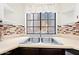 Bright kitchen sink with neutral tile backsplash, stainless steel sink and view of the community at 930 N Mesa Dr # 1079, Mesa, AZ 85201