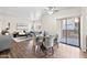 Open concept living and dining area with wood floors, neutral decor and patio access at 930 N Mesa Dr # 1079, Mesa, AZ 85201