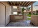 Outdoor patio view with privacy walls and nearby building with lush landscaping at 930 N Mesa Dr # 1079, Mesa, AZ 85201