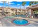 Community swimming pool with hot tub, lounge chairs, and mature palm trees at 930 N Mesa Dr # 1079, Mesa, AZ 85201