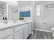 Bathroom with decorative patterned blue backsplash and white cabinets at 941 W Dexter Way, San Tan Valley, AZ 85143