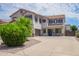Two-story home with a large driveway, tile roof, manicured landscaping, and gray accent shutters at 941 W Dexter Way, San Tan Valley, AZ 85143