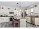 Bright kitchen with white cabinets, granite countertops, stainless steel appliances, and a center island at 941 W Dexter Way, San Tan Valley, AZ 85143