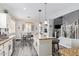 Eat-in kitchen with a center island, stone countertops, stainless appliances, and hardwood floors at 941 W Dexter Way, San Tan Valley, AZ 85143