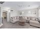 Spacious living room features plush sectional seating and soft neutral tones at 941 W Dexter Way, San Tan Valley, AZ 85143