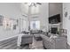 Spacious living room with soaring ceilings, a stone fireplace, and luxurious gray furnishings at 941 W Dexter Way, San Tan Valley, AZ 85143