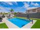 Backyard with a sparkling pool, patio furniture and basketball hoop at 941 W Dexter Way, San Tan Valley, AZ 85143