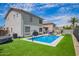 Home's backyard features a refreshing pool, artificial turf, and basketball hoop at 941 W Dexter Way, San Tan Valley, AZ 85143