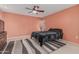 Cozy bedroom with a ceiling fan and comfortable carpet flooring at 9606 W Long Hills Dr, Sun City, AZ 85351