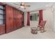 This bedroom features built-in cherry-wood closets and a ceiling fan, enhancing its appeal and comfort at 9606 W Long Hills Dr, Sun City, AZ 85351