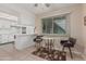 Open-concept kitchen features a breakfast bar and white cabinetry, perfect for casual dining at 9606 W Long Hills Dr, Sun City, AZ 85351