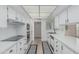 Functional kitchen features white cabinets, ample counter space and neutral tile flooring at 9606 W Long Hills Dr, Sun City, AZ 85351