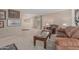 Living room with large seating area, neutral walls, and view into the adjoining room at 9606 W Long Hills Dr, Sun City, AZ 85351