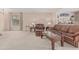 Living room with large seating area, neutral walls, and view into the adjoining room at 9606 W Long Hills Dr, Sun City, AZ 85351