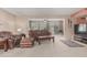 Comfortable living room with leather furniture and seamless access to patio at 9606 W Long Hills Dr, Sun City, AZ 85351