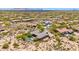 Aerial view of a home in a desert community with mountain views at 9936 E Winter Sun Dr, Scottsdale, AZ 85262