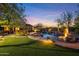 Expansive backyard with lush lawn, inviting pool, and spa offers a perfect space for outdoor enjoyment at 9936 E Winter Sun Dr, Scottsdale, AZ 85262