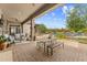Covered patio featuring outdoor seating, dining area, and pool views at 9936 E Winter Sun Dr, Scottsdale, AZ 85262