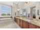 Elegant bathroom featuring dual sinks with granite countertops, a soaking tub, and a walk-in shower for a luxurious experience at 9936 E Winter Sun Dr, Scottsdale, AZ 85262