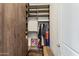 Walk-in closet with custom wood shelving, storage, and natural light at 9936 E Winter Sun Dr, Scottsdale, AZ 85262