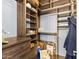 A well-organized walk-in closet with custom wood shelving and storage drawers at 9936 E Winter Sun Dr, Scottsdale, AZ 85262