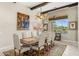 Elegant dining room features a decorative light fixture, large windows, and unique artwork at 9936 E Winter Sun Dr, Scottsdale, AZ 85262