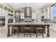 Spacious kitchen featuring a large island with seating, stainless steel appliances, and custom white cabinetry at 9936 E Winter Sun Dr, Scottsdale, AZ 85262