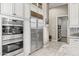 Stainless steel refrigerator and double oven in kitchen, with ample storage space at 9936 E Winter Sun Dr, Scottsdale, AZ 85262