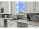 Modern kitchen with stainless steel appliances, granite countertops, and a view at 9936 E Winter Sun Dr, Scottsdale, AZ 85262