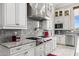 Bright kitchen boasts granite countertops, stainless steel appliances, and white cabinets at 9936 E Winter Sun Dr, Scottsdale, AZ 85262