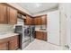 Well-equipped laundry room featuring modern appliances, custom cabinetry, and a sink for added convenience and functionality at 9936 E Winter Sun Dr, Scottsdale, AZ 85262