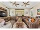 Spacious living room features a leather sectional sofa, hardwood floors, and natural lighting at 9936 E Winter Sun Dr, Scottsdale, AZ 85262