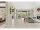 Bright living room with a fireplace, tile flooring, and large windows with desert views at 9936 E Winter Sun Dr, Scottsdale, AZ 85262