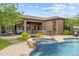 Inviting backyard featuring a pool with a built-in hot tub, a covered patio, and an outdoor bar at 9936 E Winter Sun Dr, Scottsdale, AZ 85262