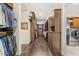Expansive walk-in closet with custom wood shelving, providing ample storage and organization adjacent to laundry appliances at 9936 E Winter Sun Dr, Scottsdale, AZ 85262