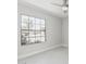 Bedroom featuring neutral paint, updated flooring, large window and a ceiling fan at 1019 W Mohawk Ln, Phoenix, AZ 85027