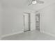 Bedroom features neutral paint, updated flooring, a ceiling fan, and mirrored closet at 1019 W Mohawk Ln, Phoenix, AZ 85027