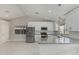 Open concept kitchen with stainless appliances, white cabinets and granite countertops at 1019 W Mohawk Ln, Phoenix, AZ 85027