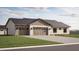 Exterior elevation of a charming single story home showcasing a two car garage and desert landscaping at 11203 E Crescent Ave, Mesa, AZ 85208