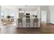 Bright, modern kitchen with white cabinetry, stainless steel appliances, and a spacious center island with seating at 11203 E Crescent Ave, Mesa, AZ 85208