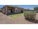 View of the backyard with a small grass area, desert landscaping, and covered patio at 11625 N 153Rd Dr, Surprise, AZ 85379