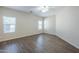 Spacious bedroom featuring wood floors, a ceiling fan, and two windows at 11625 N 153Rd Dr, Surprise, AZ 85379