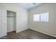 Bedroom with a closet, wood flooring, and a window at 11625 N 153Rd Dr, Surprise, AZ 85379