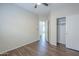 Bedroom view showcasing a sliding door closet and wood floors at 11625 N 153Rd Dr, Surprise, AZ 85379
