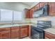 Efficient kitchen with an oven, microwave, and granite countertops at 11625 N 153Rd Dr, Surprise, AZ 85379