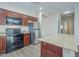 A kitchen showcasing wood cabinets, stainless steel refrigerator, granite countertops, and black oven at 11625 N 153Rd Dr, Surprise, AZ 85379