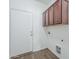 The laundry room includes ample cabinet storage and washer and dryer hookups at 11625 N 153Rd Dr, Surprise, AZ 85379