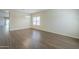 Open-concept living room with wood-look flooring, neutral walls and plenty of space at 11625 N 153Rd Dr, Surprise, AZ 85379