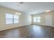 Inviting living room featuring stylish wood-look floors and large windows with blinds at 11625 N 153Rd Dr, Surprise, AZ 85379